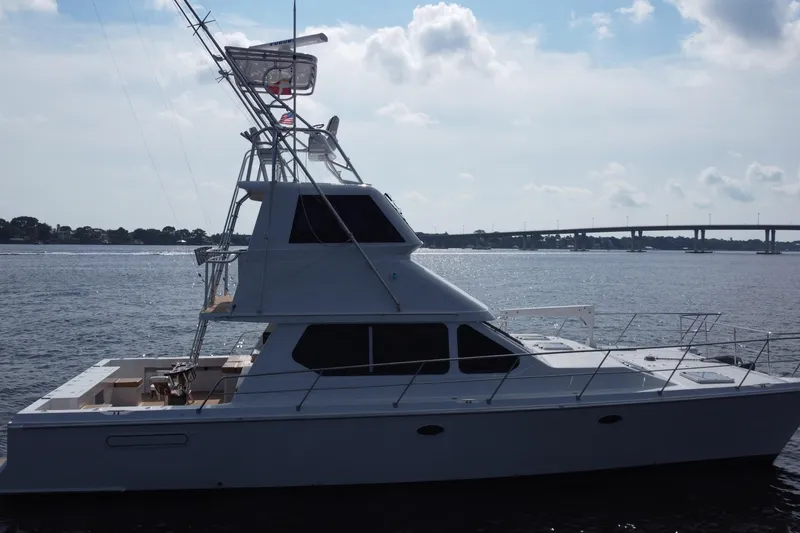 Slide: The Image of Voyager 44 yacht from 2000 on calm waters with bridge in background. - 18