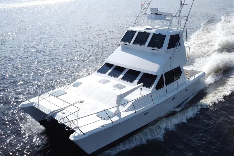 Slide: The Image of Luxurious 2000 Voyager 44 yacht cruising on open water, showcasing sleek design and elegance. - 2