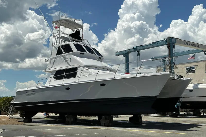 Slide: The Image of Voyager 44 yacht from 2000 on dry dock at Apex Marine under cloudy sky. - 21