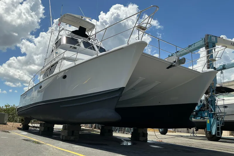 Slide: The Image of Voyager 44 yacht from 2000 on dry dock under a bright blue sky. - 22