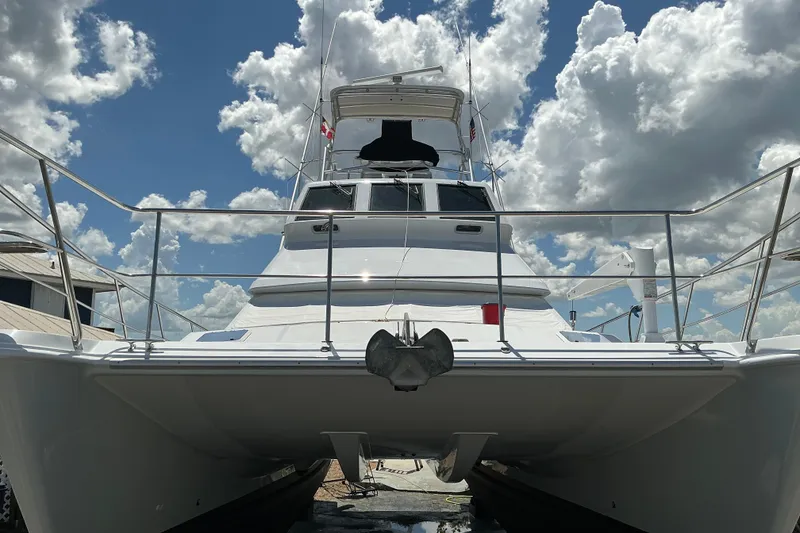 Slide: The Image of Voyager 44 yacht from 2000, docked under a partly cloudy sky. - 23