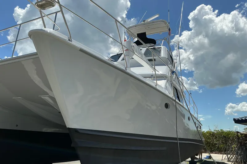 Slide: The Image of 2000 Voyager 44 yacht under a bright blue sky with clouds. - 24
