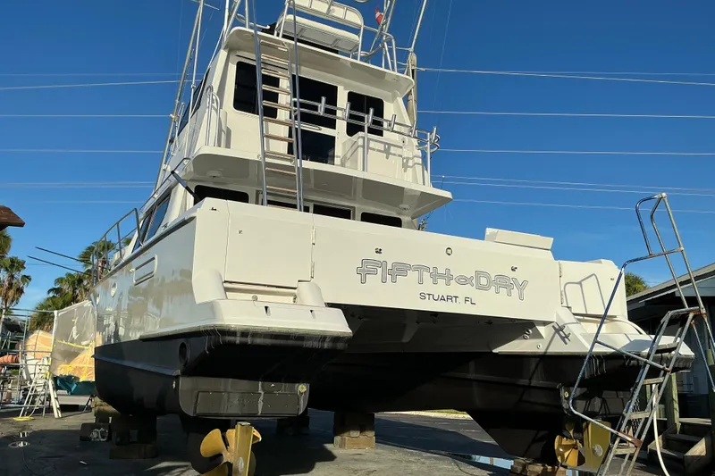 Slide: The Image of Voyager 44 yacht from 2000, named "Fifth Day," docked in Stuart, FL. - 25