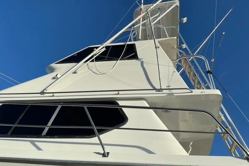 Slide: The Image of Voyager 44 yacht, 2000 model, featuring sleek design and modern structure against clear blue sky. - 27