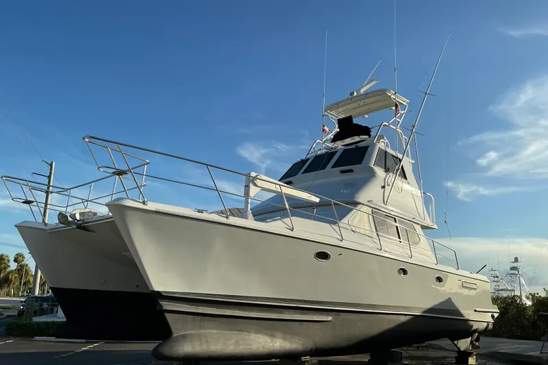 Slide: The Image of Voyager 44 yacht from 2000 on land, under clear blue sky. - 28