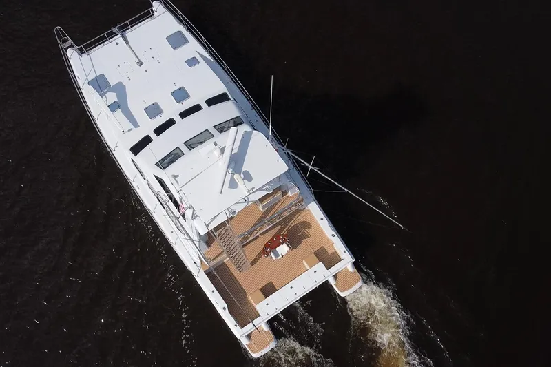 Slide: The Image of Aerial view of 2000 Voyager 44 yacht cruising on dark water. - 3