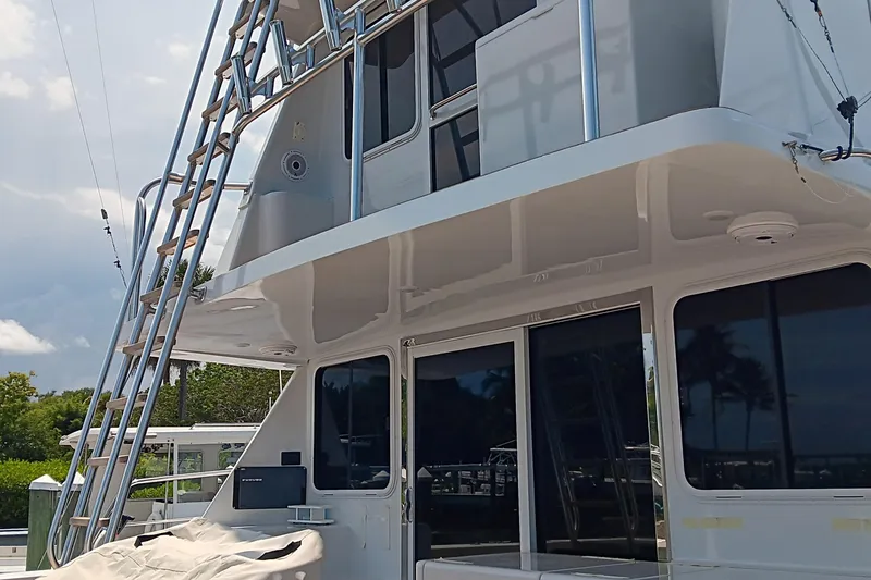 Slide: The Image of Voyager 44 yacht, 2000 model, featuring sleek design and outdoor ladder. - 31