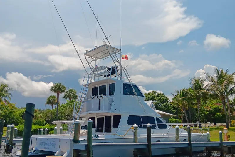 Slide: The Image of Voyager 44 yacht docked, surrounded by palm trees and a clear blue sky. - 32