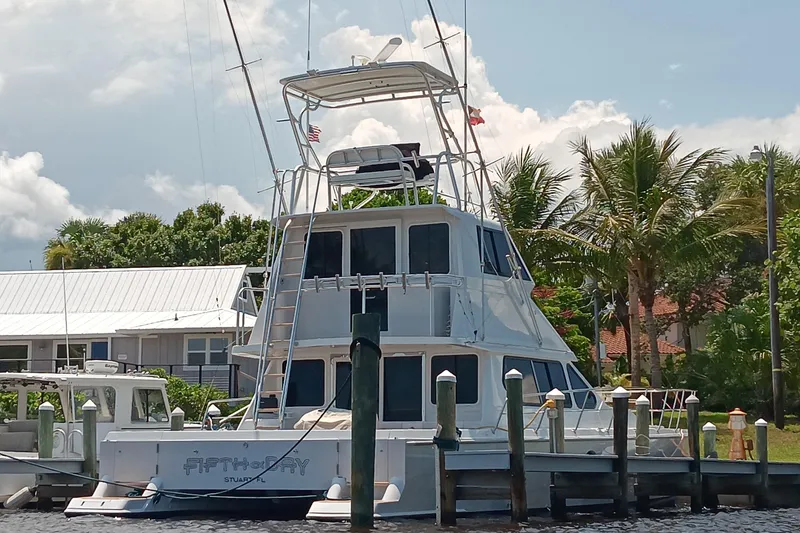 Slide: The Image of Voyager 44 yacht docked near palm trees, showcasing sleek design, 2000 model. - 33
