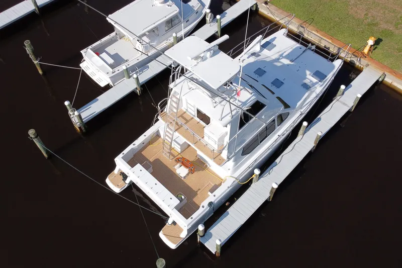 Slide: The Image of Aerial view of a 2000 Voyager 44 yacht docked at a marina. - 34