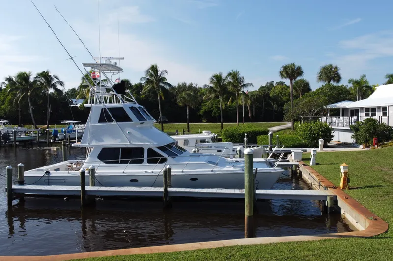 Slide: The Image of Voyager 44 yacht docked at marina, surrounded by palm trees, sunny day, 2000 model. - 35
