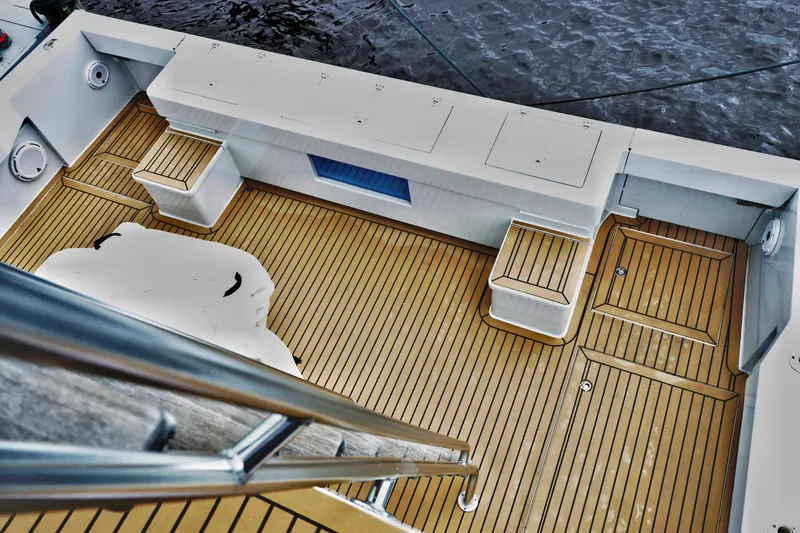 Slide: The Image of Venturer 44 yacht deck, 2000 model, featuring sleek wooden flooring and storage compartments. - 37