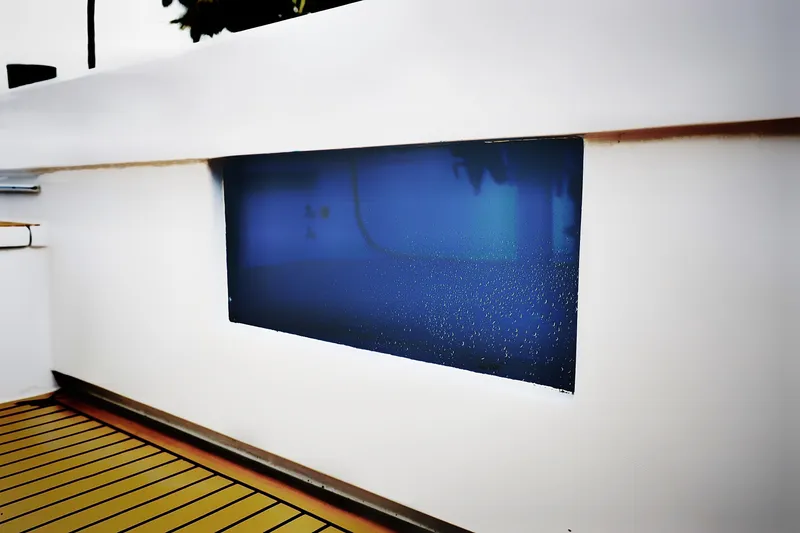Slide: The Image of Venturer 44 yacht window with raindrops, showcasing sleek design, 2000 model. - 38