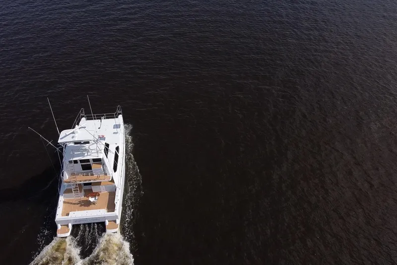 Slide: The Image of Aerial view of 2000 Voyager 44 yacht cruising on open water. - 4