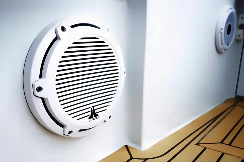 Slide: The Image of White JL Audio speaker on Venturer 44 boat, 2000 model, with teak-style flooring. - 42