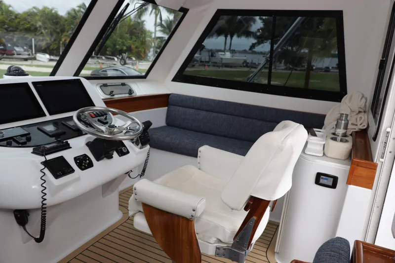 Slide: The Image of Interior of 2000 Venturer 44 yacht with helm, seating, and navigation equipment. - 44