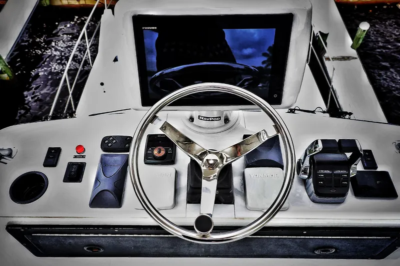 Slide: The Image of Steering console of a 2000 Venturer 44 boat with navigation controls. - 46