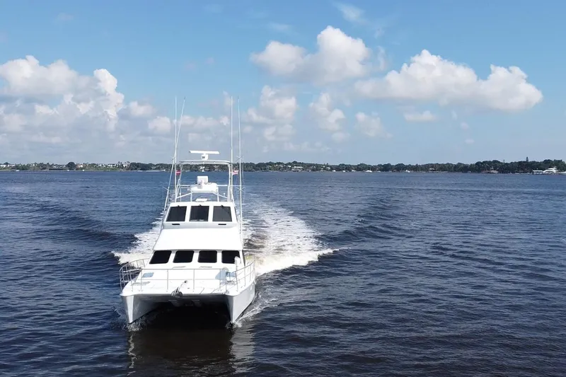 Slide: The Image of Voyager 44 yacht cruising on a calm lake under a clear blue sky. - 5