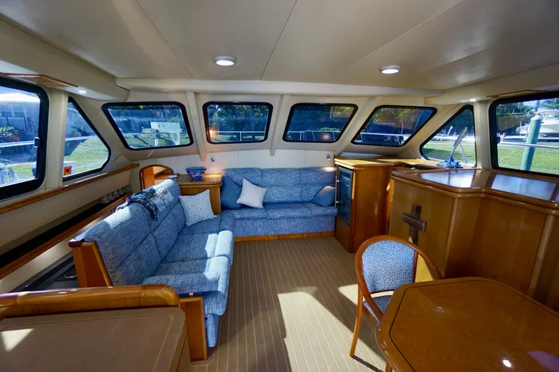 Slide: The Image of Luxurious interior of 2000 Venturer 44 yacht with blue seating and wooden accents. - 59