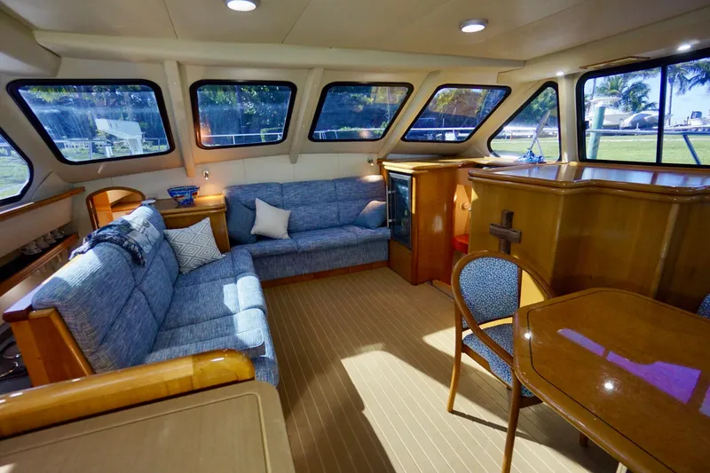 Slide: The Image of Luxurious interior of a 2000 Venturer 44 yacht with plush seating and elegant wood finishes. - 60