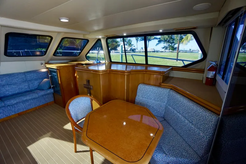 Slide: The Image of Luxurious interior of 2000 Venturer 44 yacht with elegant seating and panoramic windows. - 61