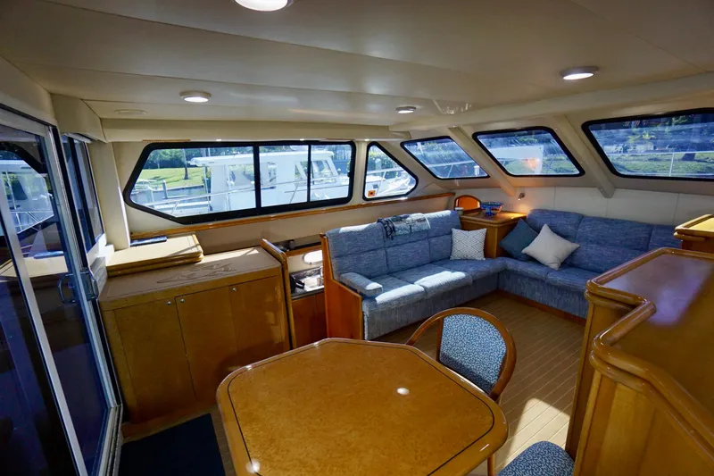 Slide: The Image of Luxurious interior of 2000 Venturer 44 yacht with spacious seating and elegant wood finishes. - 62