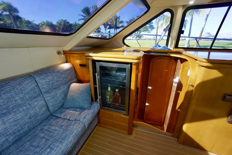 Slide: The Image of Interior of 2000 Venturer 44 yacht with sofa, mini fridge, and wooden cabinetry. - 65