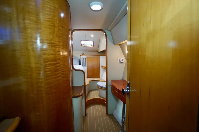 Slide: The Image of Interior of 2000 Venturer 44 yacht, featuring wood paneling and cozy cabin space. - 67