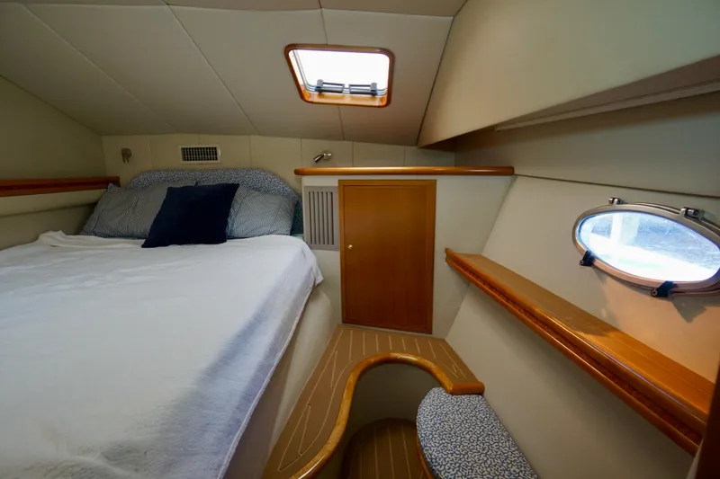 Slide: The Image of Cozy cabin interior of 2000 Venturer 44 yacht with bed and porthole window. - 69
