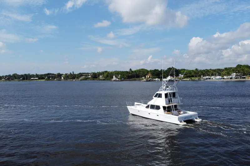 Slide: The Image of Voyager 44 yacht cruising on a calm river under a partly cloudy sky. - 7