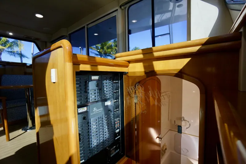 Slide: The Image of Interior of 2000 Venturer 44 yacht showing control panel and wooden cabinetry. - 75