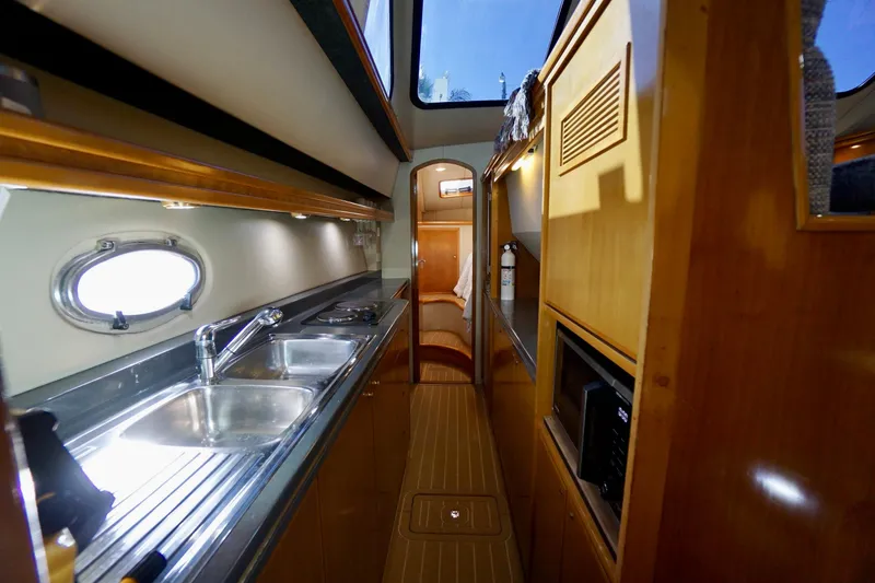 Slide: The Image of 2000 Venturer 44 yacht interior with modern kitchen and wood finish. - 76