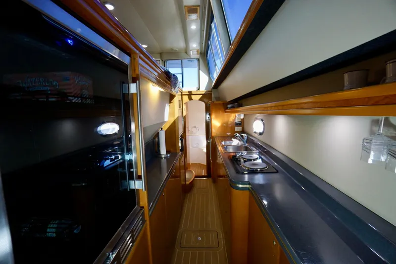 Slide: The Image of Luxurious interior of 2000 Venturer 44 yacht, featuring modern kitchen and sleek design. - 78