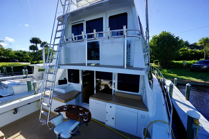 Slide: The Image of Luxury Venturer 44 yacht from 2000 docked, featuring spacious deck and seating area. - 81