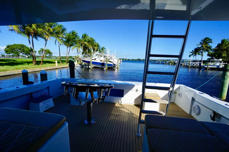 Slide: The Image of Venturer 44 yacht deck with scenic marina view, palm trees, and clear blue sky. - 83