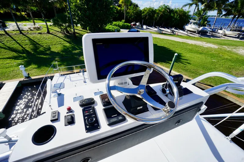 Slide: The Image of Helm of 2000 Venturer 44 yacht with steering wheel and navigation controls. - 85