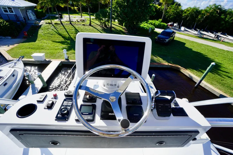 Slide: The Image of Helm of 2000 Venturer 44 yacht with navigation controls and steering wheel. - 86