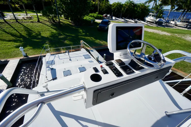 Slide: The Image of Helm of 2000 Venturer 44 yacht with steering wheel and control panel. - 87