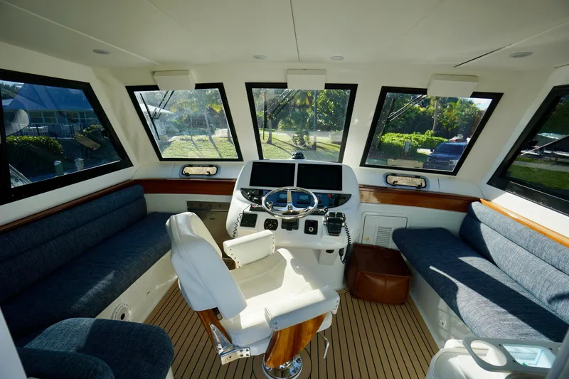 Slide: The Image of Interior of 2000 Venturer 44 yacht with helm, seating, and panoramic windows. - 93