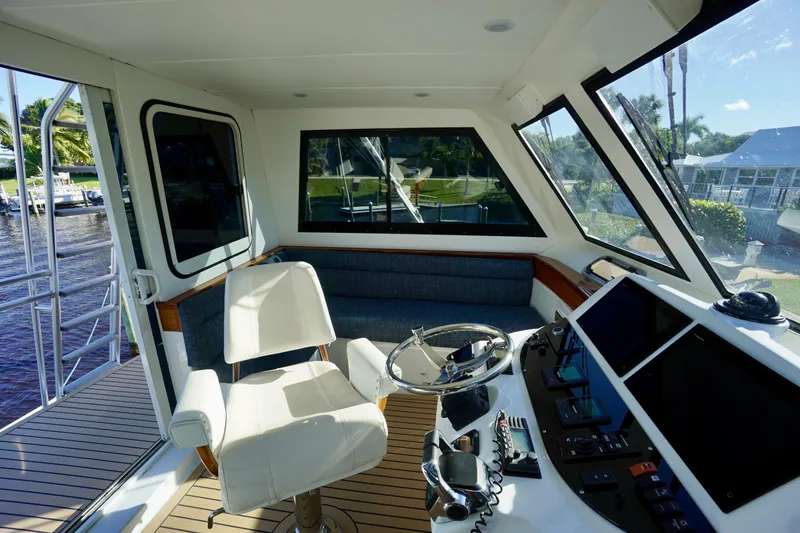 Slide: The Image of Interior of 2000 Venturer 44 yacht with helm, seating, and navigation equipment. - 95