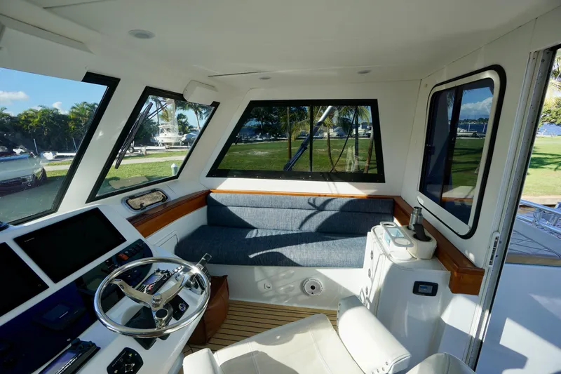 Slide: The Image of Interior of 2000 Venturer 44 boat with steering wheel and seating area. - 96