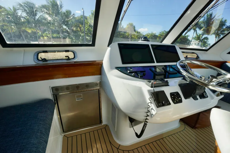 Slide: The Image of Cockpit of 2000 Venturer 44 yacht with modern controls and steering wheel. - 97