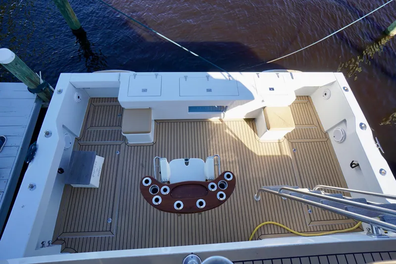 Slide: The Image of Spacious deck of 2000 Venturer 44 boat with seating and rod holders. - 99