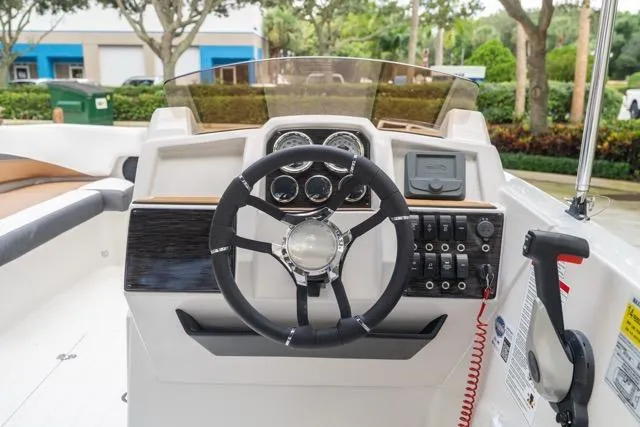 Slide: The Image of 2026 Starcraft SVX 211 OB boat dashboard with steering wheel and control panel. - 12