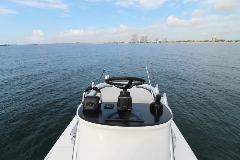 Slide: The Image of 2019 Jupiter 30 HFS boat helm with ocean view and distant city skyline. - 17