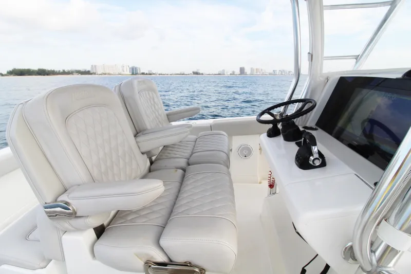 Slide: The Image of 2019 Jupiter 30 HFS boat interior with luxurious seating and modern helm controls. - 4