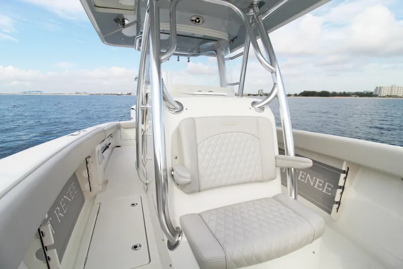 Slide: The Image of 2019 Jupiter 30 HFS boat interior with cushioned seating, ocean view, and clear sky. - 8
