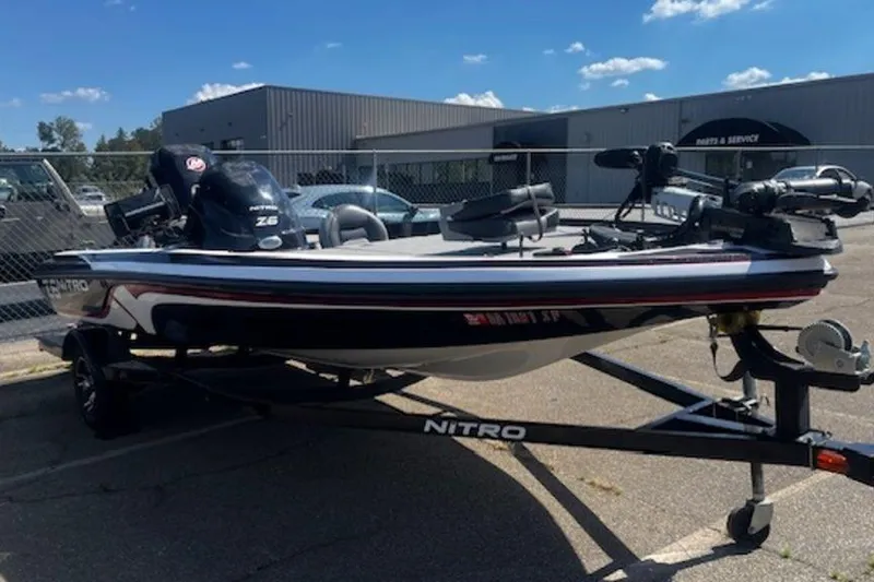 Slide: The Image of 2013 Nitro Z Series Z-6 boat on trailer, parked outdoors under blue sky. - 4
