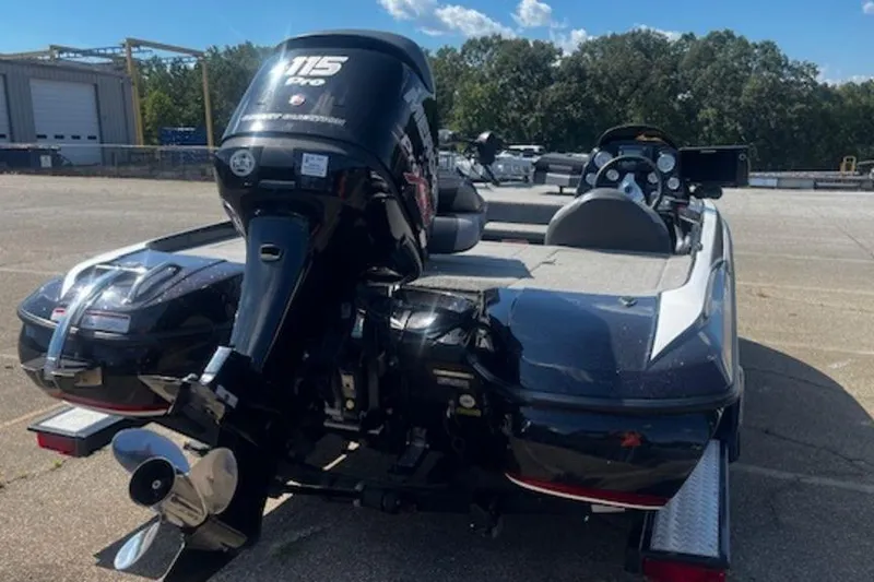 Slide: The Image of 2013 Nitro Z Series Z-6 boat with 115 Pro outboard motor, parked outdoors. - 5