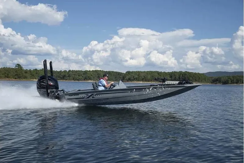 The Image of 2026 Xpress XR21 boat speeding on a lake under a clear blue sky. - 0